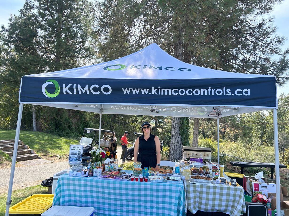 Kimco Controls team member serving guests at the tent during the SICA Golf Tournament.