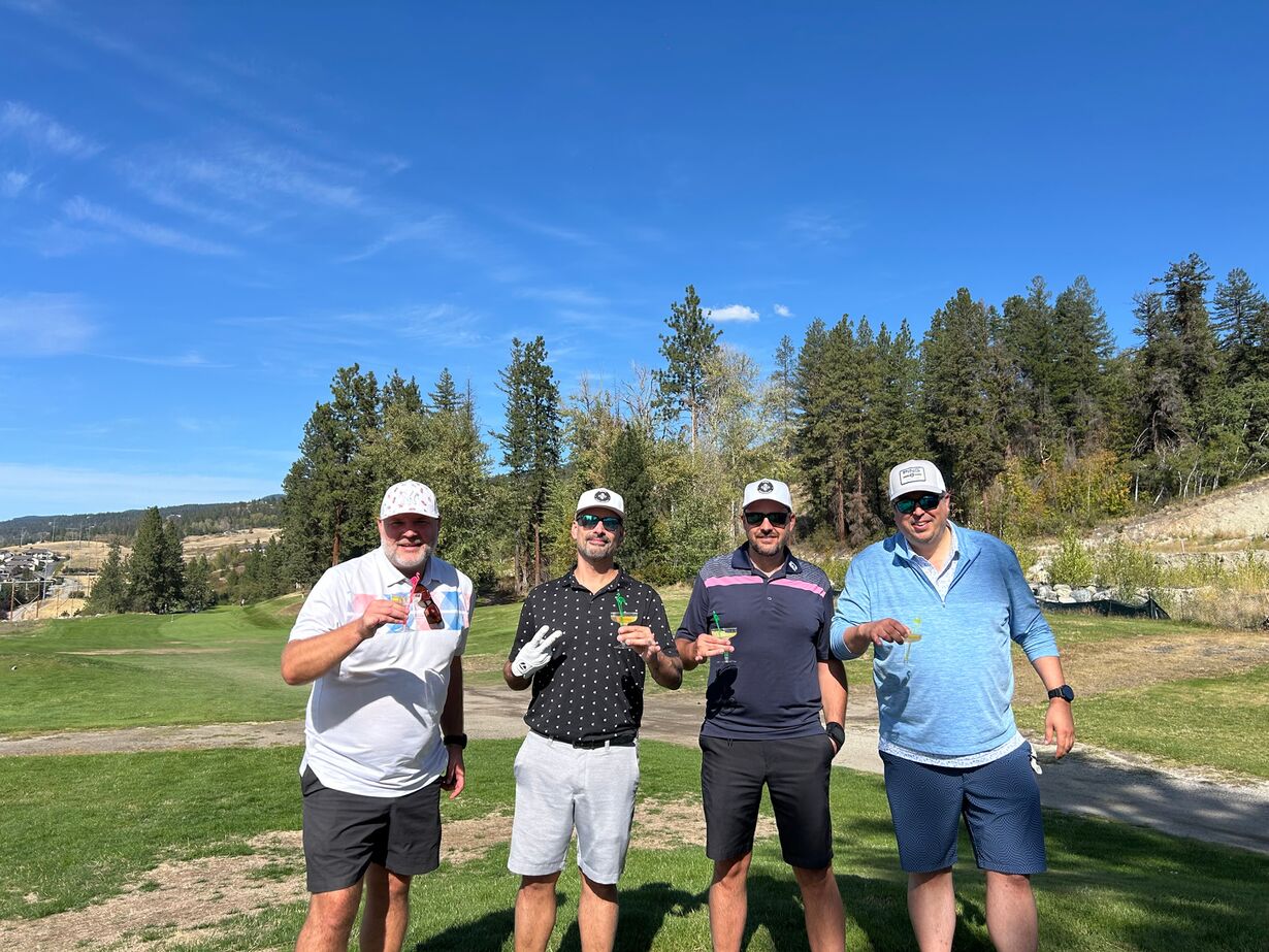 A golfer celebrating a birthday with friends and flamingo cocktails at the SICA tournament.