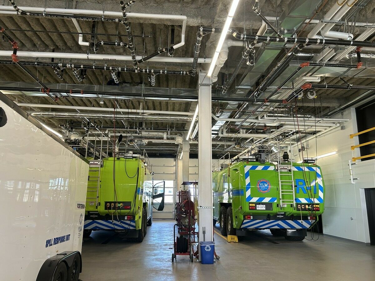 In the truck bays, in-slab radiant heating and exposed mechanical runs work around the equipment, not against it.